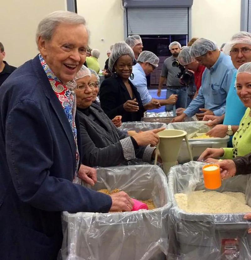 Dr. Stanley and the In Touch team pack food for orphans in Haiti.